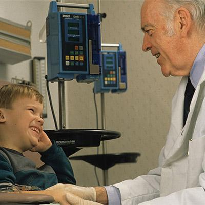 Dr. Roscoe Brady with child patient.