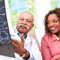 a doctor showing an Xray to a patient