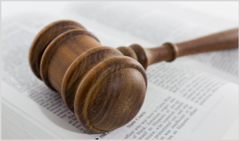 a gavel lying on top of an open book