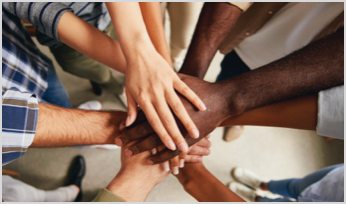 a bunch of hands stacked on top of each other