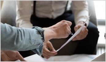 two people looking at a document