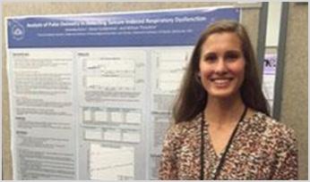 a researcher standing in front of her poster display