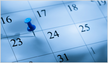 a thumbtack over a date on a calendar 