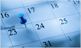 a thumbtack over a date on a calendar