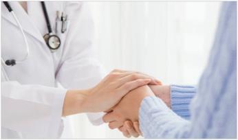 a doctor holding a patient's hands