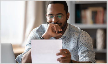 a man reading a piece of paper