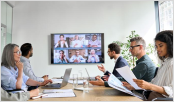 Diverse company employees having online business conference video call on tv screen monitor in board meeting room.