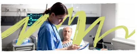 Female physician looking at medical records of patient, an elderly man, lying in a hospital bed.