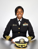 U.S. Public Health Service officer in dress uniform seated with a service cap.