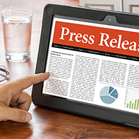 Person using tablet looking at press release article