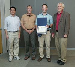 Photo of Bryan Mosher (holding certificate) NINDS 2014 Exceptional Summer Student Award Recipient