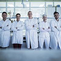 Team of scientists stanidng in a lab