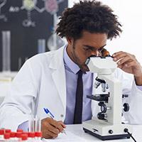 Scientist looking into a microscope
