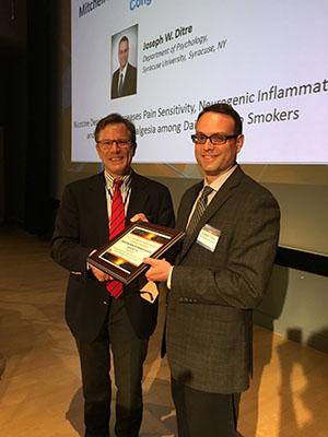 Dr. Wilson Compton, Deputy Director, NIDA presents the Mitchell Max Award for Best Junior Investigator Presentation Dr. Joseph Ditre of Syracuse University