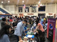 NINDS staff demonstrate activities to children and adults in the gymnasium at Morgan State University for the 2022 STEM Day Extravaganza.