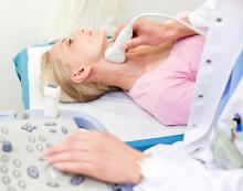 Woman undergoing a carotid doppler ultrasound, which measures blood flow in arteries and blood vessels in the neck.