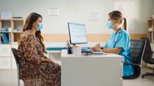 Doctor and patient meeting at a desk.