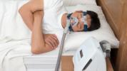 Image of a man wearing a CPAP machine while sleeping.