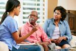 Medical provider speaking to two African American patients