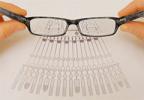 Image of eyeglasses being held over paper with a symmetric image
