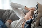 tired woman laying on couch